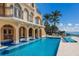 Luxury waterfront home with a stunning pool and multiple lounge areas at 309 Ringling Point Dr, Sarasota, FL 34234