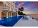 Beautiful home featuring a waterfront pool with lounge chairs and open patio space overlooking the bay at 309 Ringling Point Dr, Sarasota, FL 34234