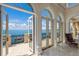 Open French doors lead to a balcony overlooking the water at 309 Ringling Point Dr, Sarasota, FL 34234