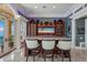 Custom wet bar with granite countertop and built-in TV at 309 Ringling Point Dr, Sarasota, FL 34234