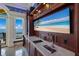 Modern wet bar with beer tap and large-screen TV at 309 Ringling Point Dr, Sarasota, FL 34234