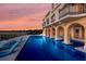 Luxury waterfront home with expansive pool and sunset views at 309 Ringling Point Dr, Sarasota, FL 34234