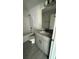 Bathroom with shower over bath, granite countertop on vanity, modern fixtures, and neutral design at 3249 Vickers Ln, North Port, FL 34286