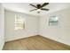 Bright bedroom with two windows, ceiling fan, and light wood flooring at 3535 16Th N St, St Petersburg, FL 33704