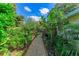 Lush garden path with tropical plants and a wooden gate at 4718 Crystal Ave, Sarasota, FL 34231