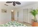 Tropical style bedroom with ceiling fan, closet, and leaf-print bedding at 4718 Crystal Ave, Sarasota, FL 34231