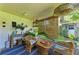 Cozy sunroom with wicker furniture, bamboo blinds, and tropical plants at 4718 Crystal Ave, Sarasota, FL 34231