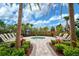 Relaxing hot tub surrounded by lush landscaping and lounge chairs at 4734 Tortona Ct, Bradenton, FL 34211