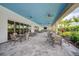 Relaxing outdoor patio with covered seating, ceiling fans, and lush landscaping at 4734 Tortona Ct, Bradenton, FL 34211