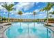 Resort-style pool with lounge chairs and palm trees at 4734 Tortona Ct, Bradenton, FL 34211