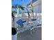 Enjoy the ocean view from this furnished balcony, featuring comfy chairs at 475 Benjamin Franklin Dr # 202, Sarasota, FL 34236