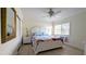 Bright bedroom with a ceiling fan, white bed frame, and tiled floors at 475 Benjamin Franklin Dr # 202, Sarasota, FL 34236