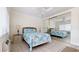Serene bedroom with mirrored closet, ceiling fan, and tiled floors at 475 Benjamin Franklin Dr # 202, Sarasota, FL 34236