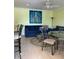 Relaxing living room featuring a blue sofa, dining table, and ocean-themed art at 475 Benjamin Franklin Dr # 202, Sarasota, FL 34236