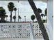 Relaxing ocean view from the balcony, with palm trees and beach access at 475 Benjamin Franklin Dr # 202, Sarasota, FL 34236