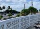 Enjoy the ocean view from this balcony, featuring a unique patterned wall and bench at 475 Benjamin Franklin Dr # 202, Sarasota, FL 34236