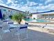 The Dorset: Pool area with tables, chairs, and palm trees at 475 Benjamin Franklin Dr # 202, Sarasota, FL 34236