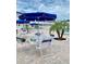 Relaxing pool area with lounge chairs, tables, and umbrellas at 475 Benjamin Franklin Dr # 202, Sarasota, FL 34236