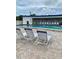 The Dorset: Pool area with lounge chairs and a view of the building at 475 Benjamin Franklin Dr # 202, Sarasota, FL 34236