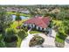 Luxury home with red tile roof, circular driveway, and lush landscaping at 5156 Little Brook Ct, Sarasota, FL 34238