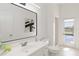 Modern bathroom with white vanity, large mirror, and pool view at 5156 Little Brook Ct, Sarasota, FL 34238