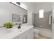 Clean bathroom with gray tile, white vanity, and bathtub at 5156 Little Brook Ct, Sarasota, FL 34238