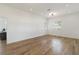 Light and airy bedroom with wood floors and access to a kitchen at 5156 Little Brook Ct, Sarasota, FL 34238