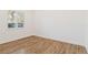 Simple bedroom with wood floors and a window with shutters at 5156 Little Brook Ct, Sarasota, FL 34238