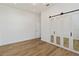 Well-lit bedroom with wood floors and mirrored closet doors at 5156 Little Brook Ct, Sarasota, FL 34238