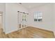 Bedroom with mirrored closet doors and wood floors at 5156 Little Brook Ct, Sarasota, FL 34238