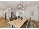 Spacious dining room with hardwood floors, chandelier, and kitchen view at 5156 Little Brook Ct, Sarasota, FL 34238