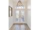 Bright entryway with hardwood floors and glass double doors at 5156 Little Brook Ct, Sarasota, FL 34238