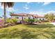 Single-Gathering home with red tile roof, landscaping, and large yard at 5156 Little Brook Ct, Sarasota, FL 34238