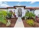 Front entrance with double doors, landscaping, and walkway at 5156 Little Brook Ct, Sarasota, FL 34238