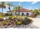 One-story house with red tile roof, lush landscaping, and stone accents at 5156 Little Brook Ct, Sarasota, FL 34238