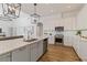 White kitchen with stainless steel appliances and a large island at 5156 Little Brook Ct, Sarasota, FL 34238