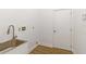 Laundry room with utility sink and built-in cabinets at 5156 Little Brook Ct, Sarasota, FL 34238