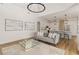 Open living area with hardwood floors, gray sofa, and kitchen views at 5156 Little Brook Ct, Sarasota, FL 34238