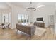 Living room with hardwood floors, sliding glass doors to the pool, and comfortable seating at 5156 Little Brook Ct, Sarasota, FL 34238