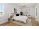 Main bedroom with plush bed, hardwood floors, and window seating at 5156 Little Brook Ct, Sarasota, FL 34238