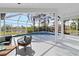 Relaxing pool and spa area with screened enclosure, overlooking a tranquil lake at 5156 Little Brook Ct, Sarasota, FL 34238