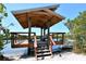 Wooden gazebo providing waterfront relaxation spot at 5450 Eagles Point Cir # 405, Sarasota, FL 34231