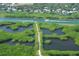 Breathtaking aerial view highlighting the lush mangroves, waterways, and nearby coastal homes at 5450 Eagles Point Cir # 405, Sarasota, FL 34231