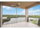 Screened balcony with a ceiling fan showcasing breathtaking views of the bay and tropical landscape at 5450 Eagles Point Cir # 405, Sarasota, FL 34231