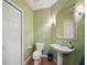 Bathroom with decorative wallpaper and stand alone sink at 5450 Eagles Point Cir # 405, Sarasota, FL 34231