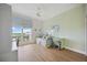 Bright bedroom features wood floors, ceiling fan, and a large window with blue patterned curtains at 5450 Eagles Point Cir # 405, Sarasota, FL 34231