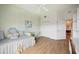 Bright bedroom features wood floors, and a large window with patterned curtains at 5450 Eagles Point Cir # 405, Sarasota, FL 34231
