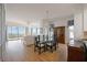 Spacious dining room with hardwood floors, glass table, and a chandelier at 5450 Eagles Point Cir # 405, Sarasota, FL 34231