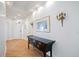 Bright entryway with hardwood floors, console table, and elegant wall sconces at 5450 Eagles Point Cir # 405, Sarasota, FL 34231