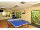 Well-lit recreation room with ping pong table and fitness equipment at 5450 Eagles Point Cir # 405, Sarasota, FL 34231